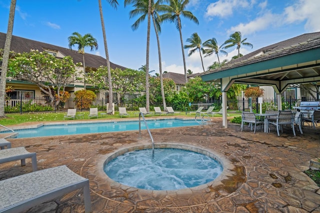 view of swimming pool with a patio and a hot tub