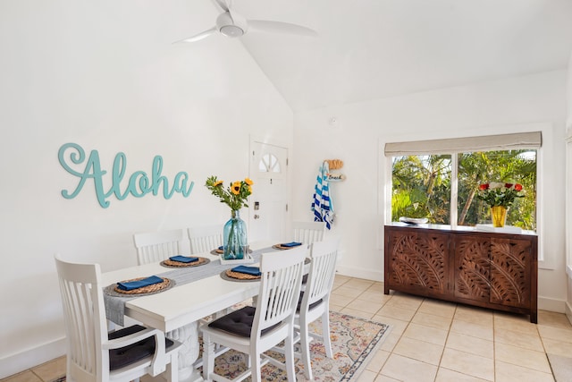 tiled dining room with ceiling fan and vaulted ceiling