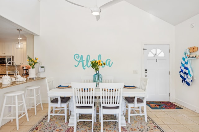 tiled dining room with high vaulted ceiling