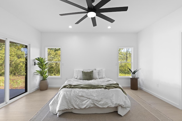 bedroom featuring access to exterior, light hardwood / wood-style flooring, and ceiling fan