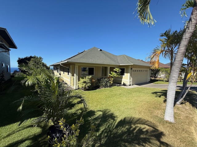 view of front of house with a front lawn and a garage