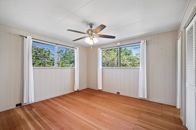 unfurnished bedroom with ceiling fan and light wood-type flooring