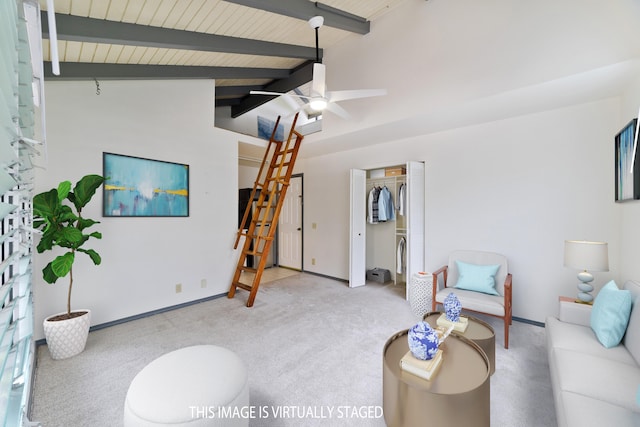 carpeted living room with ceiling fan, wood ceiling, and vaulted ceiling with beams