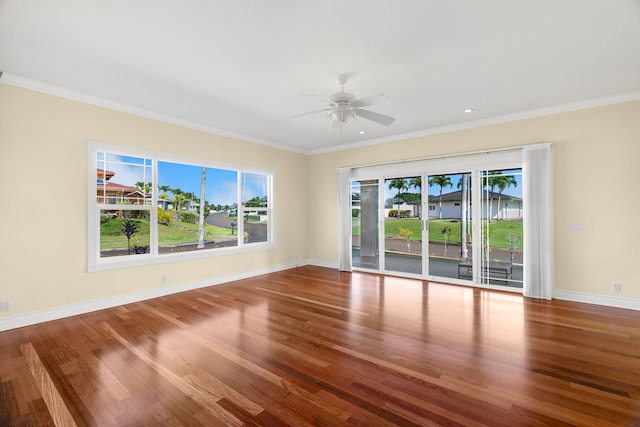 unfurnished room featuring hardwood / wood-style flooring, ceiling fan, and crown molding