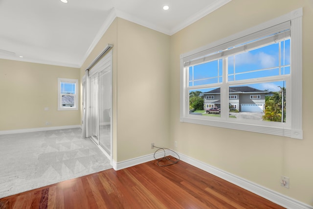 unfurnished room featuring hardwood / wood-style flooring and ornamental molding