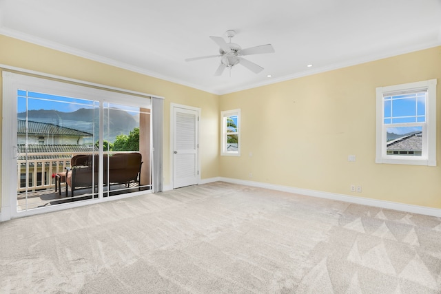 unfurnished room featuring carpet flooring, ceiling fan, and ornamental molding