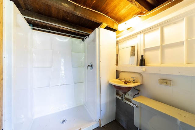 bathroom featuring wood ceiling and walk in shower