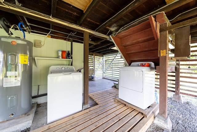 washroom with washing machine and dryer and water heater