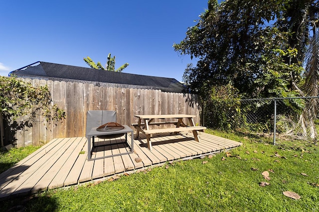 view of yard featuring a wooden deck and an outdoor fire pit