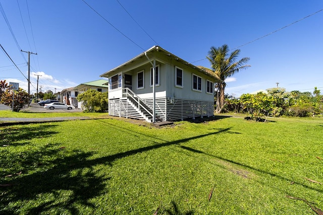 view of side of property with a lawn