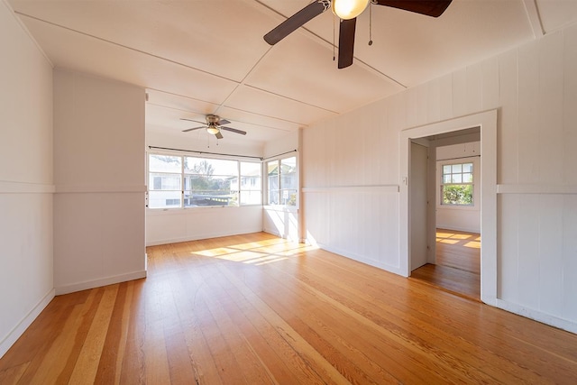 unfurnished room with ceiling fan, light hardwood / wood-style flooring, and a healthy amount of sunlight