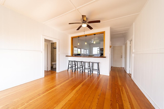 unfurnished living room with hardwood / wood-style floors and ceiling fan