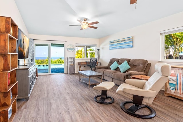 living room with light hardwood / wood-style floors and ceiling fan