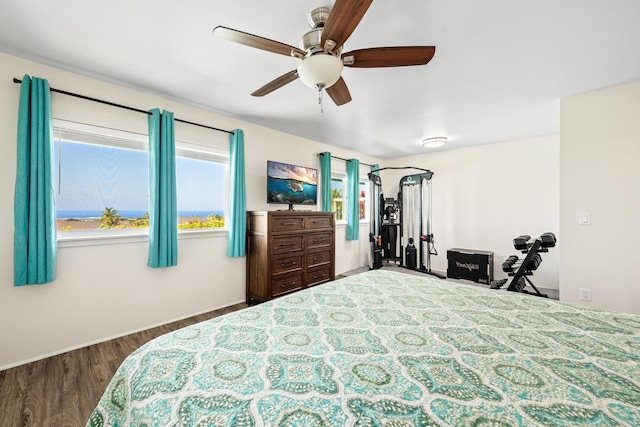 bedroom with ceiling fan and dark hardwood / wood-style floors