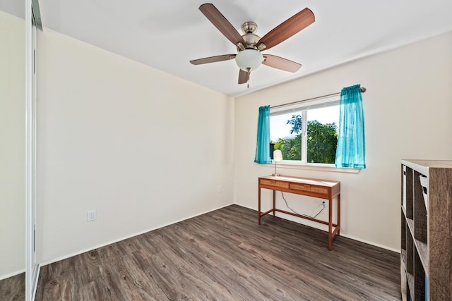 empty room with ceiling fan and dark wood-type flooring