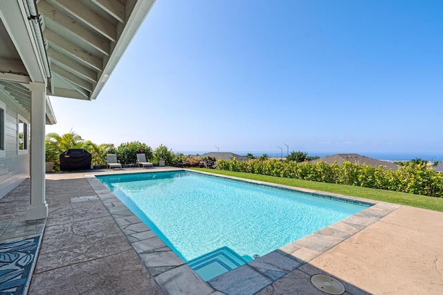 view of pool featuring a mountain view and a patio