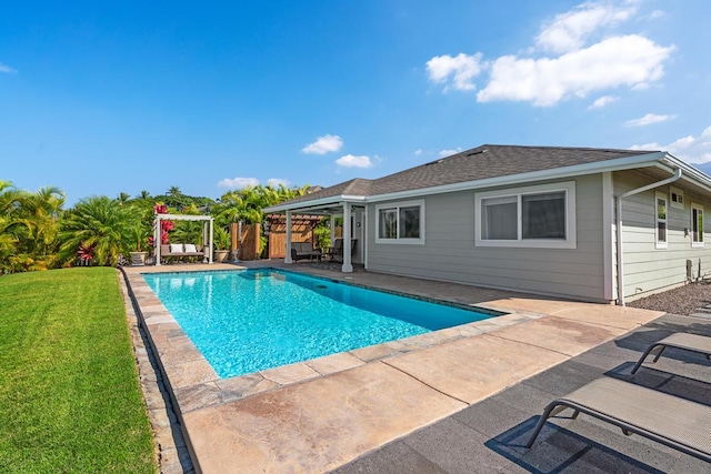 view of pool featuring a lawn and a patio area