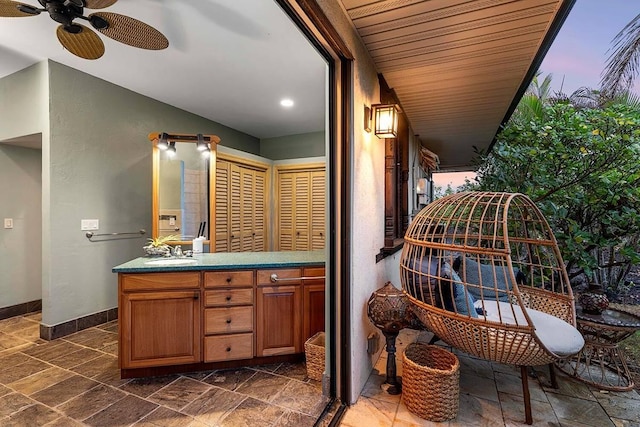 bathroom featuring ceiling fan and vanity