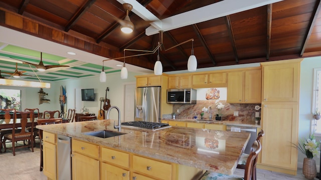 kitchen with lofted ceiling with beams, backsplash, an island with sink, wood ceiling, and appliances with stainless steel finishes