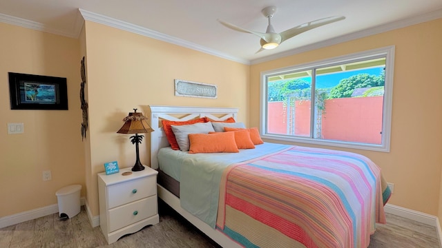 bedroom with ceiling fan, crown molding, and hardwood / wood-style flooring