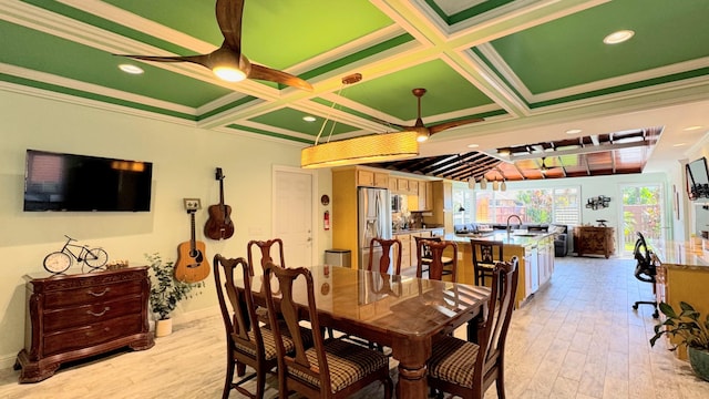 dining room featuring light hardwood / wood-style floors, ornamental molding, sink, and coffered ceiling