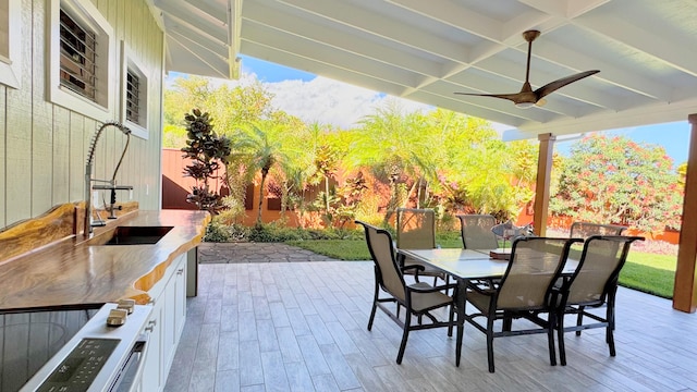 view of patio / terrace with ceiling fan and sink