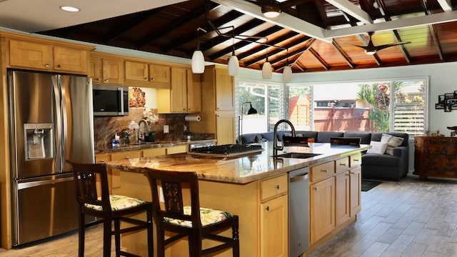 kitchen featuring decorative backsplash, appliances with stainless steel finishes, sink, wooden ceiling, and vaulted ceiling with beams