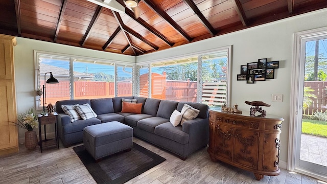 sunroom / solarium featuring lofted ceiling with beams and wooden ceiling