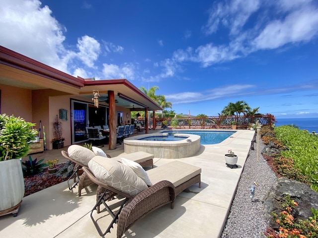 view of swimming pool with an in ground hot tub and a patio