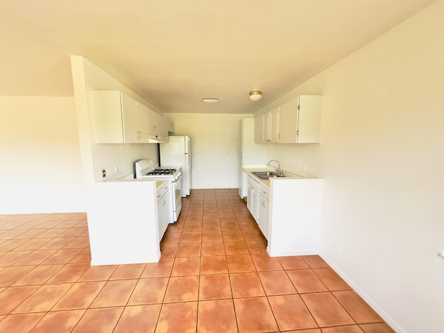 kitchen featuring white cabinetry, light tile patterned flooring, and white appliances