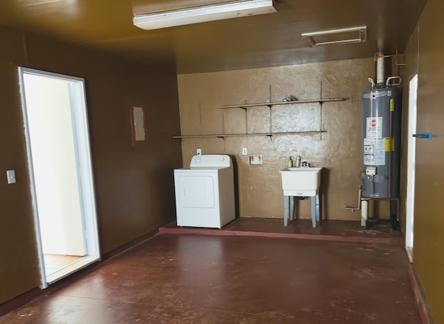 clothes washing area featuring sink, gas water heater, and washer / dryer