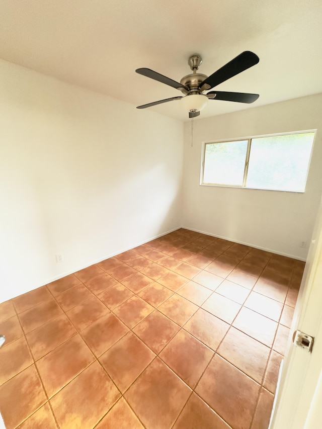 spare room with tile patterned floors and ceiling fan