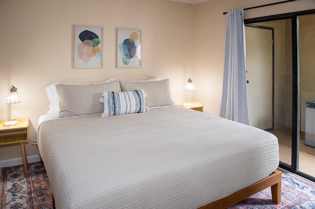 bedroom with a closet and radiator heating unit