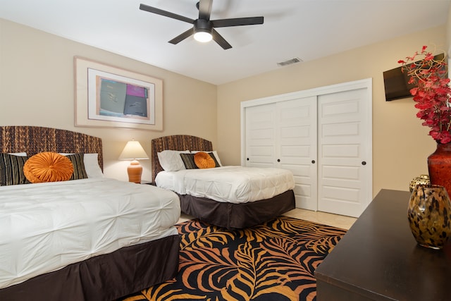 bedroom with ceiling fan and a closet