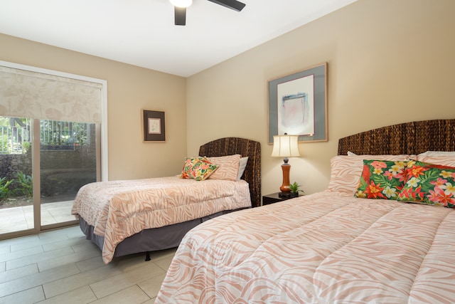 bedroom featuring ceiling fan, light tile patterned floors, and access to outside