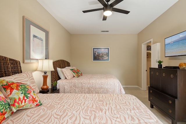 tiled bedroom featuring ceiling fan