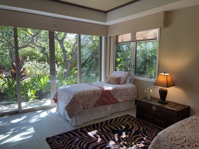 bedroom with multiple windows, crown molding, and access to outside