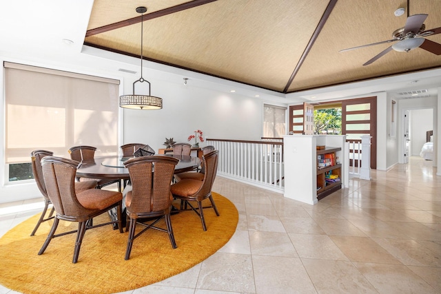 dining area with light tile patterned flooring, lofted ceiling, and a tray ceiling