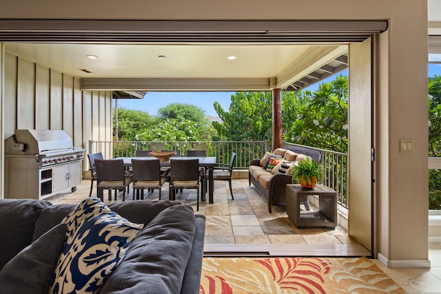 view of patio featuring a grill, an outdoor hangout area, and exterior kitchen