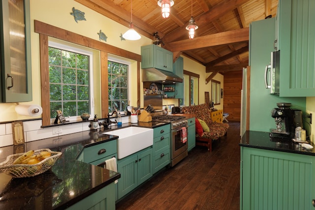 kitchen featuring stainless steel appliances, wooden walls, sink, lofted ceiling with beams, and hanging light fixtures