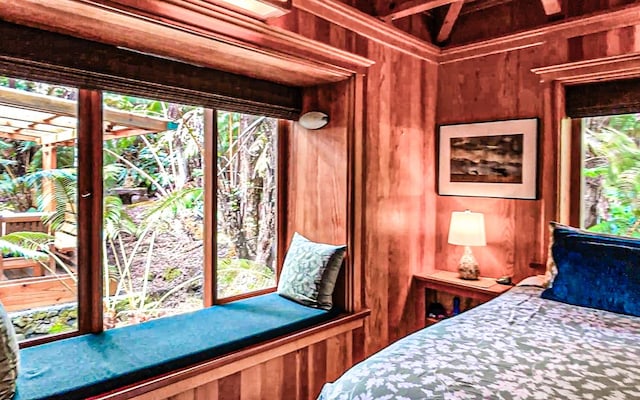 unfurnished bedroom featuring multiple windows and wood walls