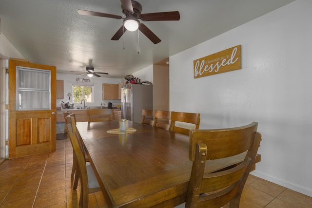 tiled dining area with a textured ceiling