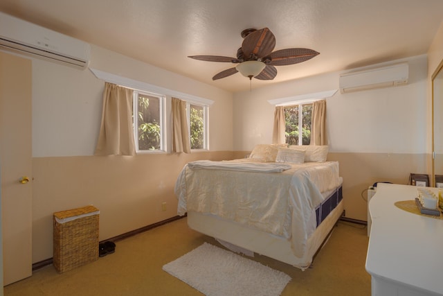 bedroom with ceiling fan, an AC wall unit, and light carpet