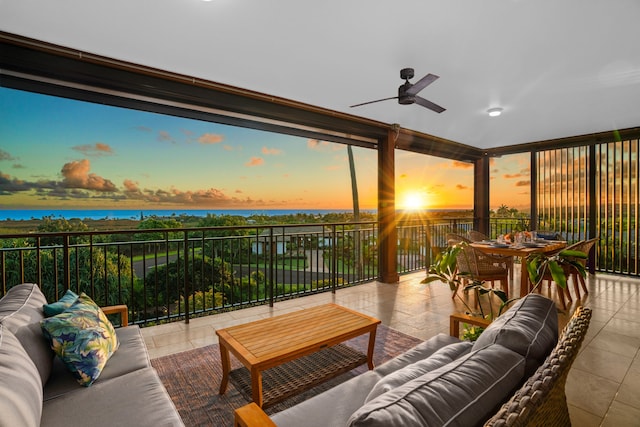 patio terrace at dusk featuring ceiling fan and outdoor lounge area