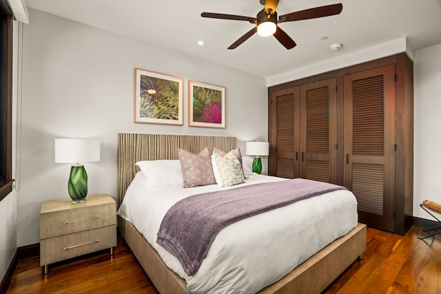 bedroom featuring dark hardwood / wood-style flooring, a closet, and ceiling fan