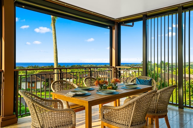 sunroom / solarium featuring a water view