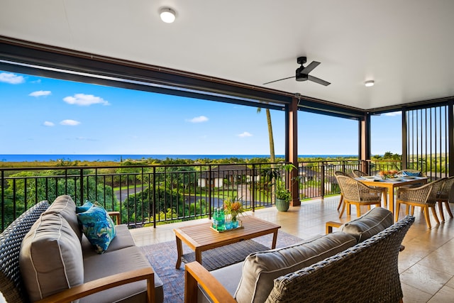 interior space with outdoor lounge area, ceiling fan, and a water view