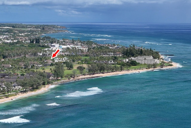 bird's eye view featuring a water view and a beach view