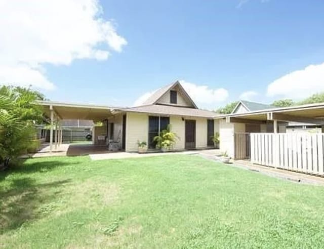 rear view of house with a yard