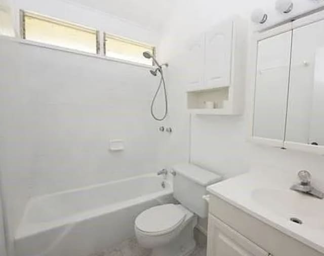 full bathroom featuring bathing tub / shower combination, vanity, and toilet